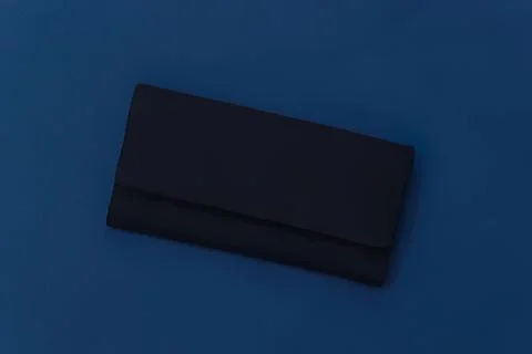 Black wallet on blue background Stock Photos