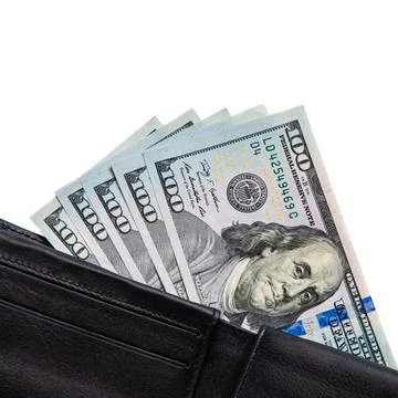 A black wallet with dollars in it on a white background. Stock Photos