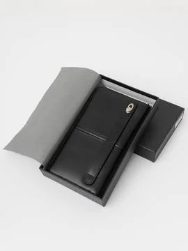 Black wallet in gift box with strap Stock Photos