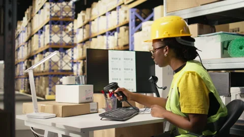 Black warehouse assistant register tracking info on tags with scanner Stock Footage 315710362