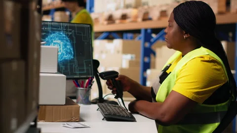 Black warehouse clerk managing orders in boxes next to AI machine learning Stock Footage 312835523
