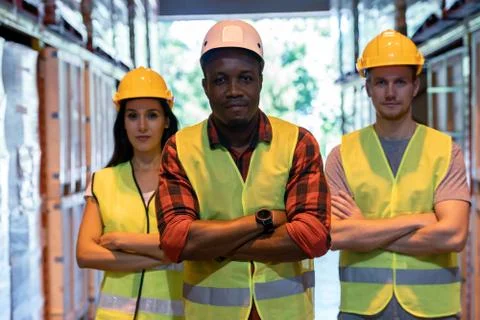 Black warehouse supervisor manager with white caucasian team Stock Photos