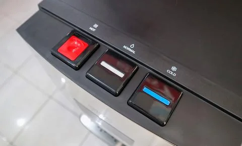 Black water dispenser control panel with hot, normal, and cold buttons 库存照片