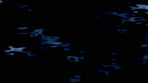 Black water. Slow motion of waves with a distorted display of the moon. Stock Footage 107598991