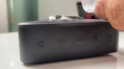 Black waterproof portable bluetooth speaker. Drop water on top. Stock Footage 250319128