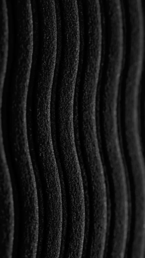 Black wavy ribbed texture slow pan. Stock Footage 337775808