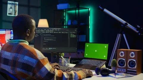 Black web developer handling database servers for safety with green screen Stock Photos