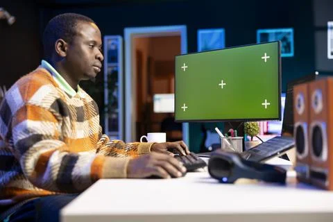 Black web developer handling database servers for safety with green screen Stock Photos