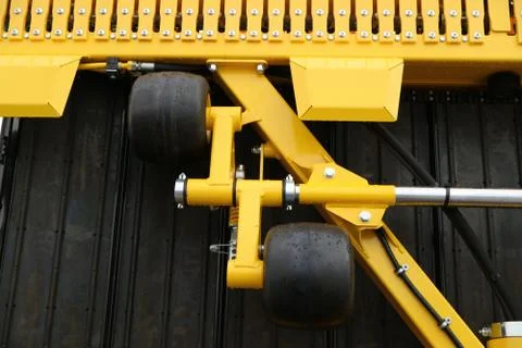Black wheels fixed on the yellow frame. Stock Photos