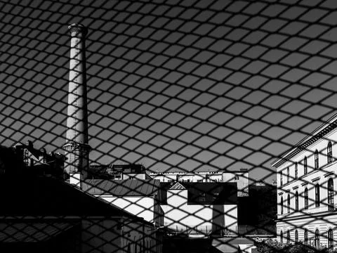Black white abstract reflection of factory chimney and brick buildings in g.. Fotos de archivo