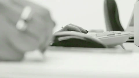 Black   White Close-up of Hands Typing on Keyboard and Using Mouse 库存影片 320523946