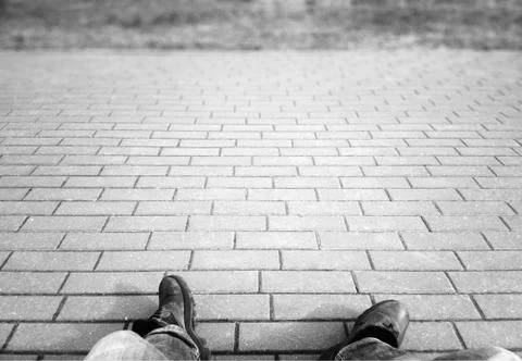 Black &amp; white hobo is seating on the street background Stock Photos