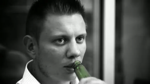 Black &amp; White Man drinking beer from the blue bottle Stock Footage 10833102