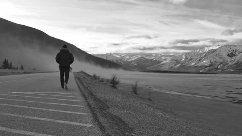 Black &amp; White Man Walking In Winter On Highway Stock Footage 290789480