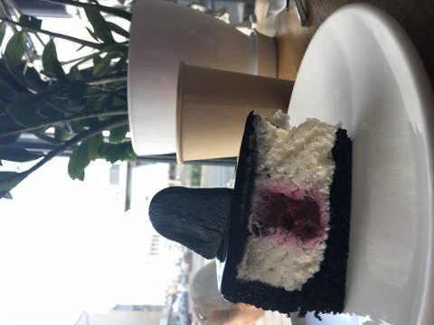 Black-white-red cake on a white plate in cafe Stock Photos