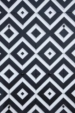 Black-white triangle patterns, old wooden door. Background, texture Stock Photos