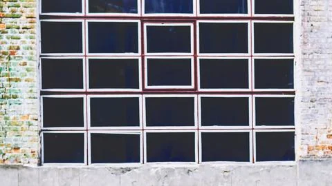 Black window with white frames on vintage old brick wall Stock Photos