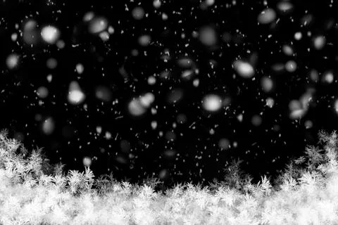 Black winter background with falling snow, glowing bokeh particles, and fro.. 스톡 사진