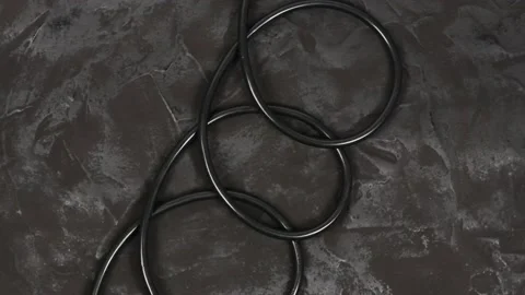 Black wire isolated on black and texture background. Top view. Stock Footage 168538838