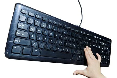 Black wired computer keyboard with child hand isolated on white background 스톡 사진