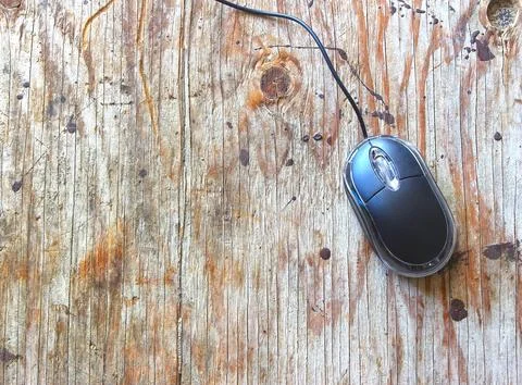 Black wired computer mouse on wood table Stock Photos