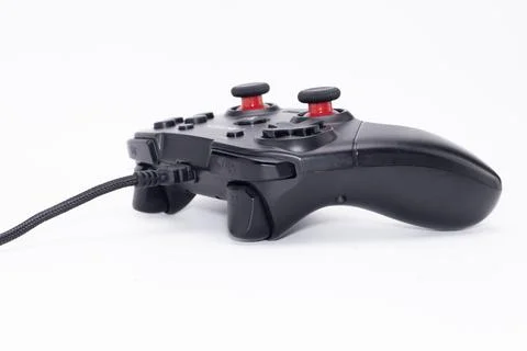 Black Wired Game Controller with Red Buttons on White Background, Gaming De.. Stock Photos