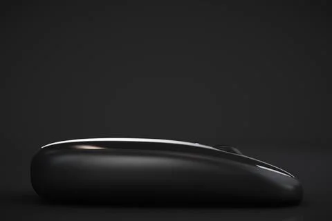 Black wireless computer mouse close up. Copy space. Dark background. Stock Photos