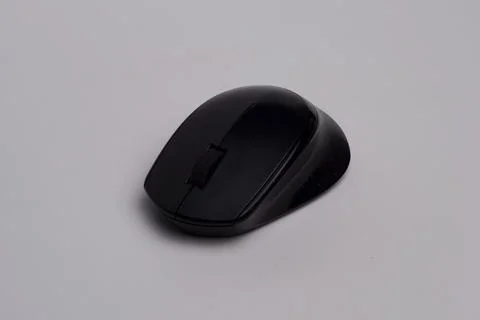 Black wireless computer mouse isolated on white background, top view. Stock Photos