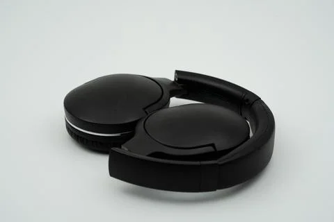 Black wireless headset folded inside Stock Photos