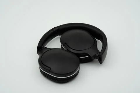 Black wireless headset folded inside close up Stock Photos