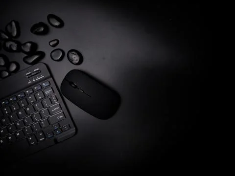 A black wireless keyboard and mouse with black stone Stock Photos