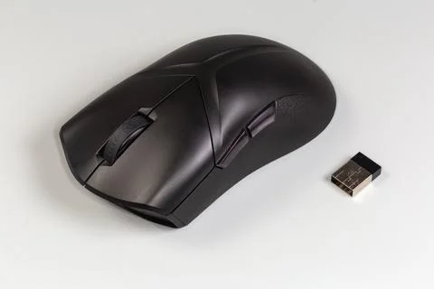 Black wireless optical computer mouse on a gray background Stock Photos