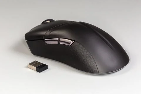 Black wireless optical computer mouse on a gray background Stock Photos