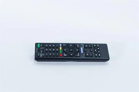 Black Wireless TV Remote Control Placed on a Clean White Surface Stock Photos