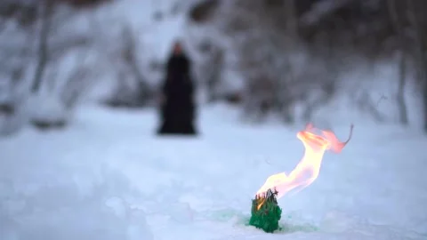 Black witch on the background of fire. witch rite. mysticism and black magic. Stock Footage 225812750