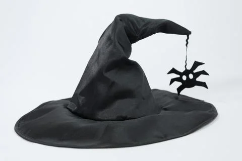 Black witch hat on a white background. Concept of magic and sorcery, stylish hat Foto stock