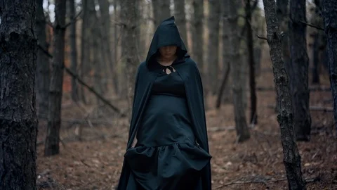 Black witch in hood walks in autumn scar, Stock Video