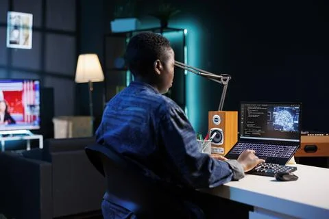 Black woman coding software on laptop 写真素材