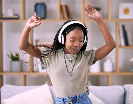 Black woman, dancing and music headphone in home living room with energy and Stock Photos