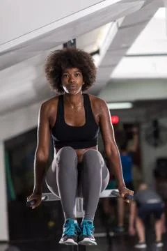 Black woman doing parallel bars Exercise Stock Photos