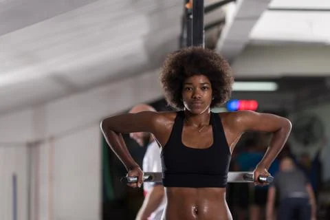 Black woman doing parallel bars Exercise Stock Photos
