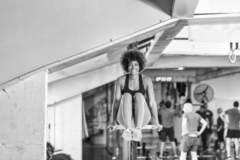 Black woman doing parallel bars Exercise Stock Photos