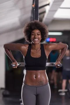 Black woman doing parallel bars Exercise Stock Photos