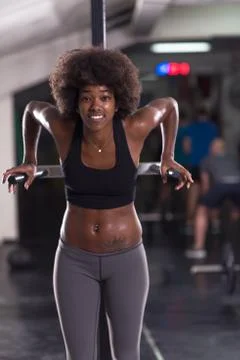 Black woman doing parallel bars Exercise Stock Photos