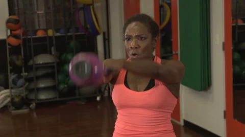A black woman doing a strenuous exercise with weight Stock Footage 44116619