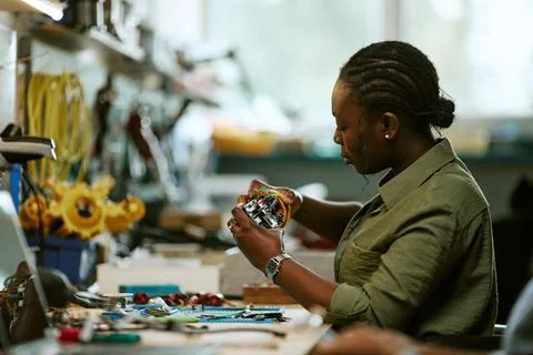 Black Woman Engineer Assembling Circuit Board in Workshop Stock Photos