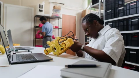 Black Woman Engineer Assembling Robotic Device in Tech Lab Stock Footage 343513993