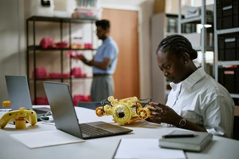 Black Woman Engineer Assembling Robotics Device in Modern Laboratory Stock Photos