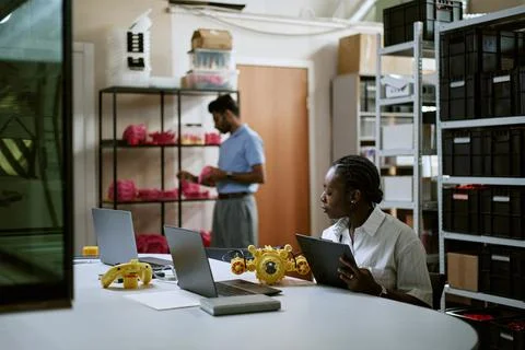 Black Woman Engineer Testing Robotics Device in Modern Tech Lab Stock Photos