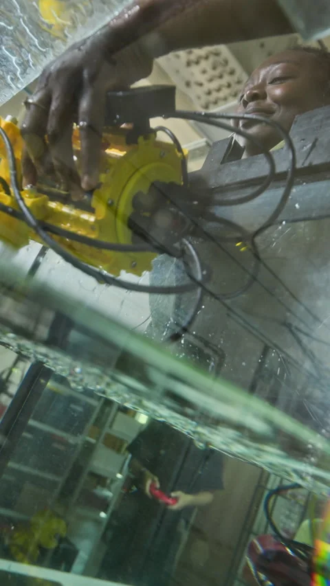 Black Woman Engineer Testing Underwater Robotic Device in Tank Stock Footage 343508026